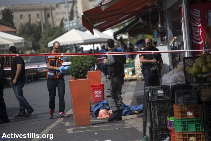 The body of a Palestinian teen is seen on the street near Damascus Gate, Jerusalem, October 10, 2015. The teen, later identified as Ishaq Badran, 16, from Kafr Aqab, was shot and killed by the Israeli police after carrying out an alleged stabbing attack in the area. (Photo: Anne Paq/Activestills.org)